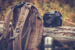 Lifestyle hiking camping equipment retro photo camera backpack a